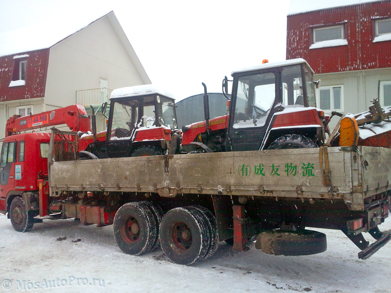 Перевозка двух тракторов Беларусь с навесным оборудованием манипулятором.